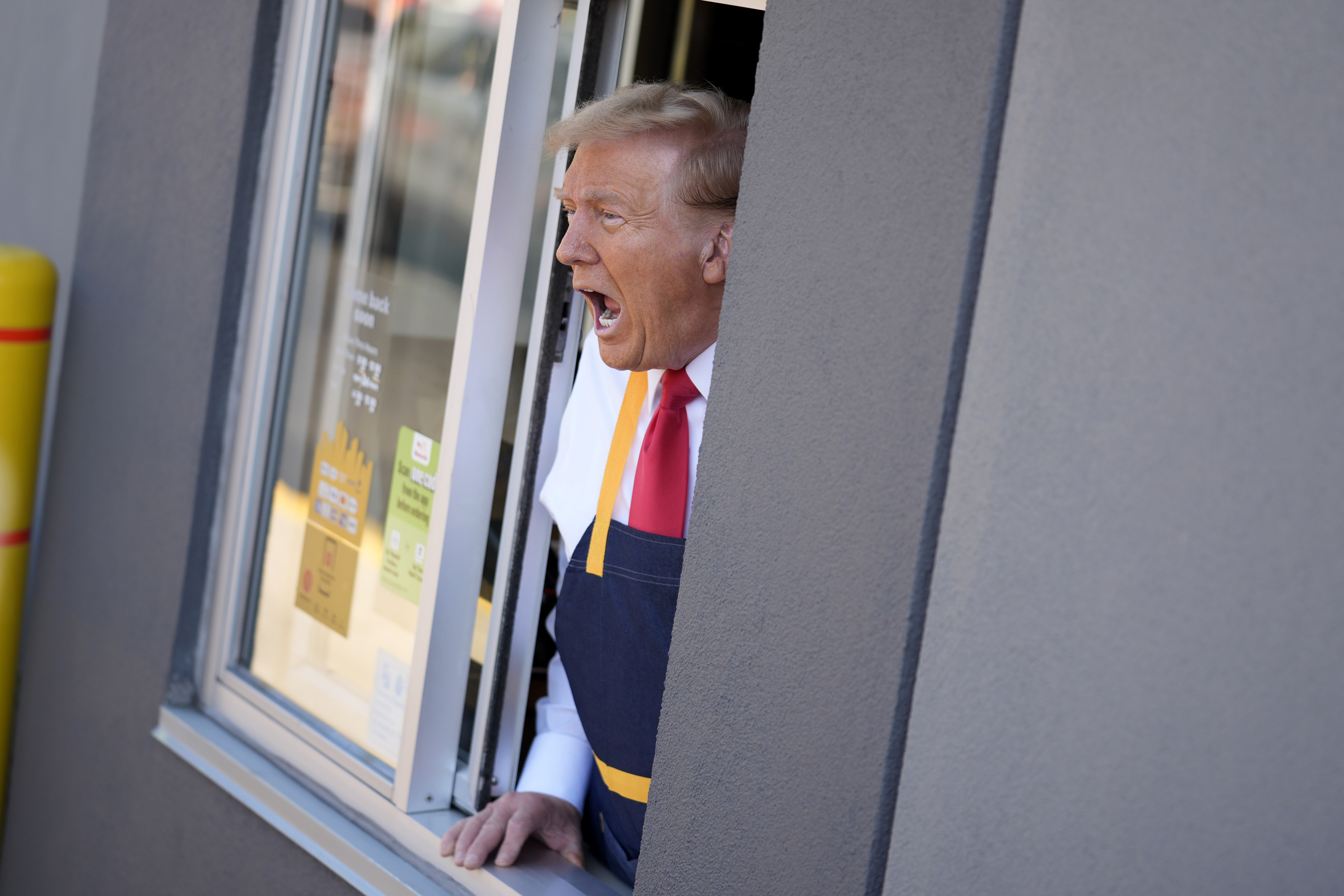 Republican presidential nominee former President Donald Trump speaks while standing at a drive-thru window during a campaign stop at a McDonald's, Sunday, Oct. 20, 2024, in Feasterville-Trevose, Pa. (AP Photo/Evan Vucci)