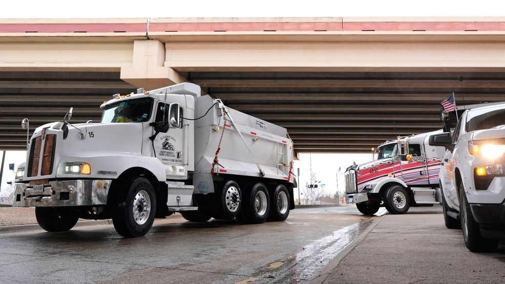 Work crews stage with de-icing materials in their trucks ahead of expected inclement weather in Plano, Texas, Friday, Jan. 23, 2026. (AP Photo/Tony Gutierrez)