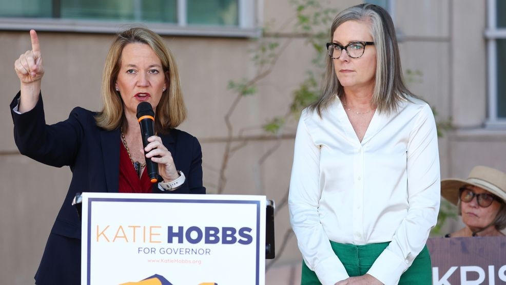 Arizona Secretary of State and Democratic gubernatorial candidate Katie Hobbs (R) looks on as Kris Mayes (L), Democratic candidate for Arizona Attorney General, speaks at a press conference calling for abortion rights.