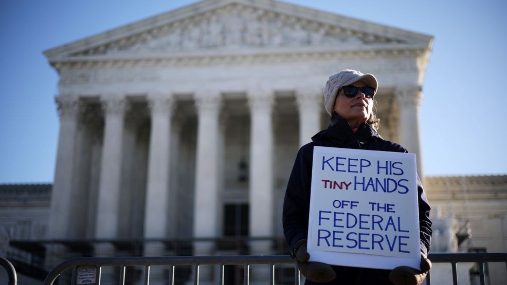 A woman holds a sign to support the Federal Reserve in front of the U.S. Supreme Court on January 21, 2026, in Washington. (Photo by Alex Wong/Getty Images)