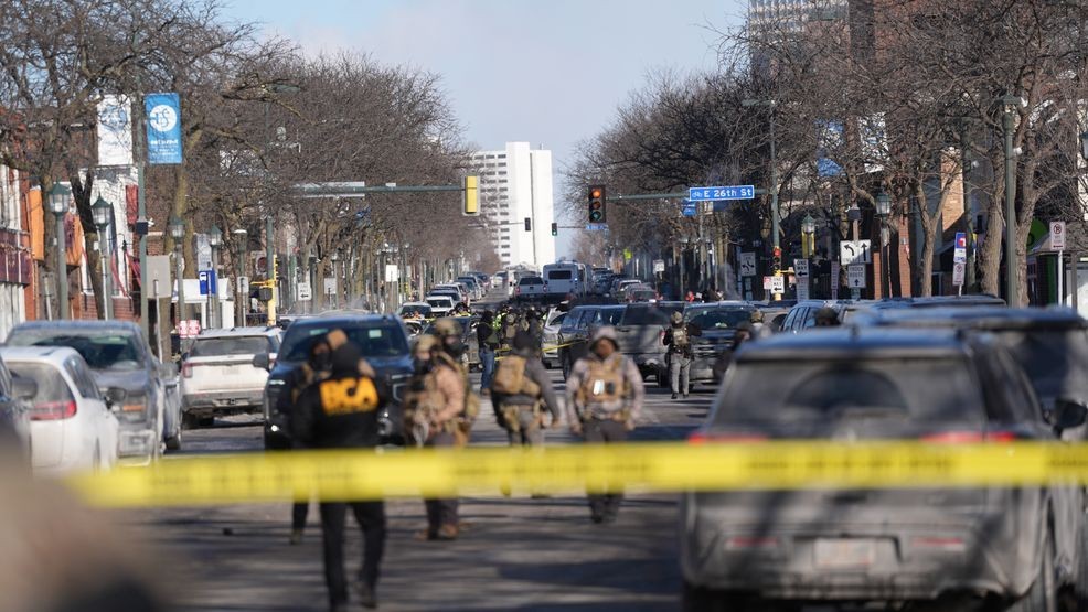Federal agents stand near the site of a shooting Saturday, Jan. 24, 2026, in Minneapolis. (AP Photo/Abbie Parr)