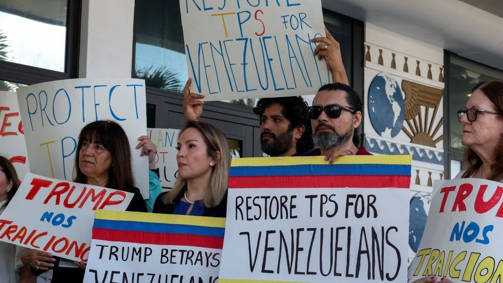 MIAMI, FLORIDA - FEBRUARY 13: Laura Kelley, Miami-Dade County Democratic Party Chair, (2nd L) joins with others to support a resolution in favor of reinstating temporary protected status for Venezuelans on February 13, 2025 in Miami, Florida. In early February, President Donald Trump's administration revoked temporary protected status for around 350,000 Venezuelans who fled the country and immigrated to the United States. (Photo by Joe Raedle/Getty Images)