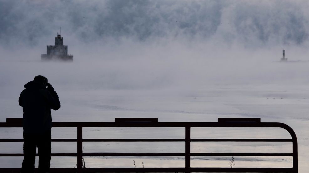Doug Kunde watches as steam is seen over Lake Michigan as frigid temperatures for the day are not expected to reach zero degrees Friday, Jan. 23, 2026, in Milwaukee. (AP Photo/Morry Gash)